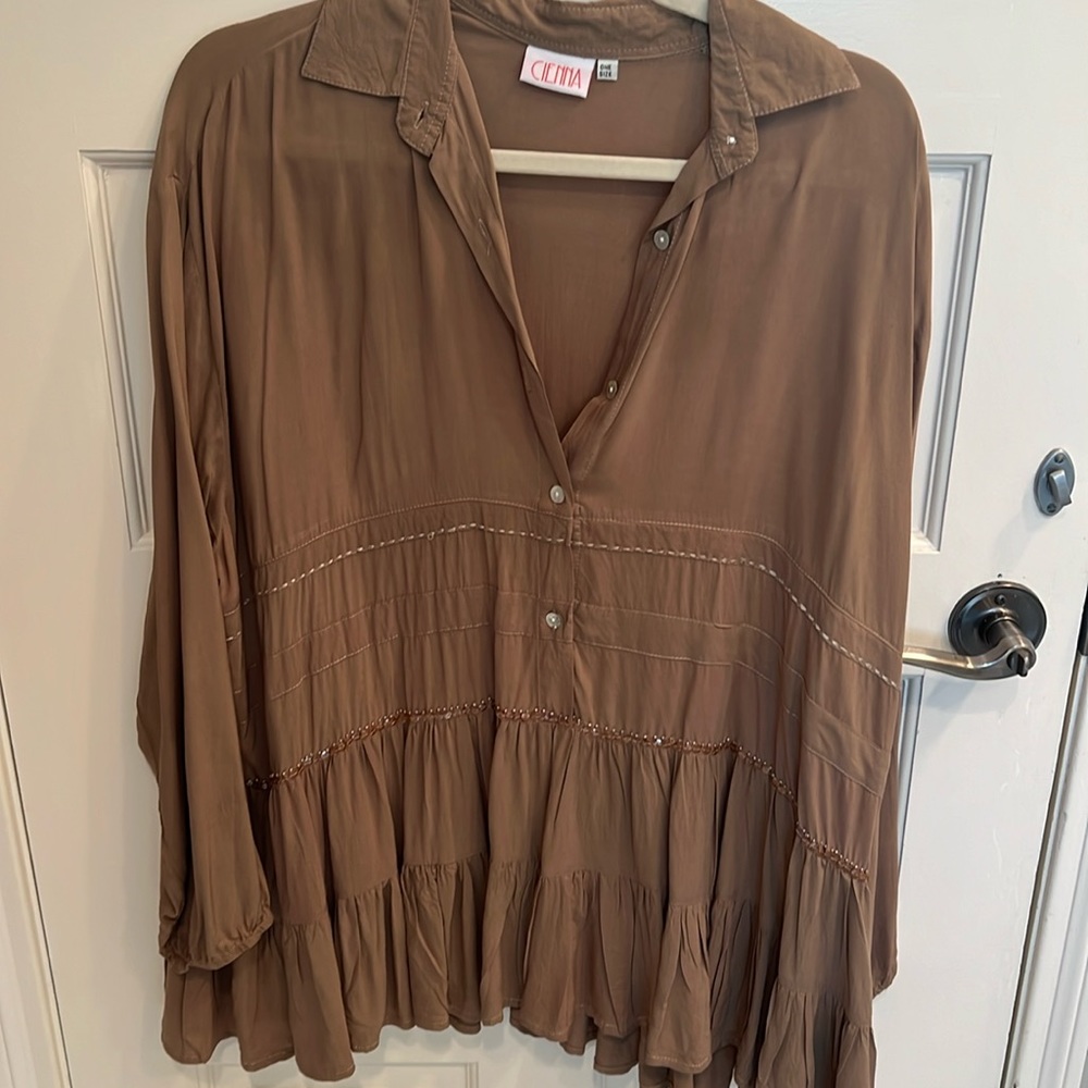 Taupe oversized top with detailed stitching and ruffles